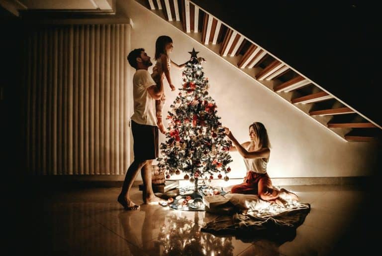 Family decorating a Christmas tree.