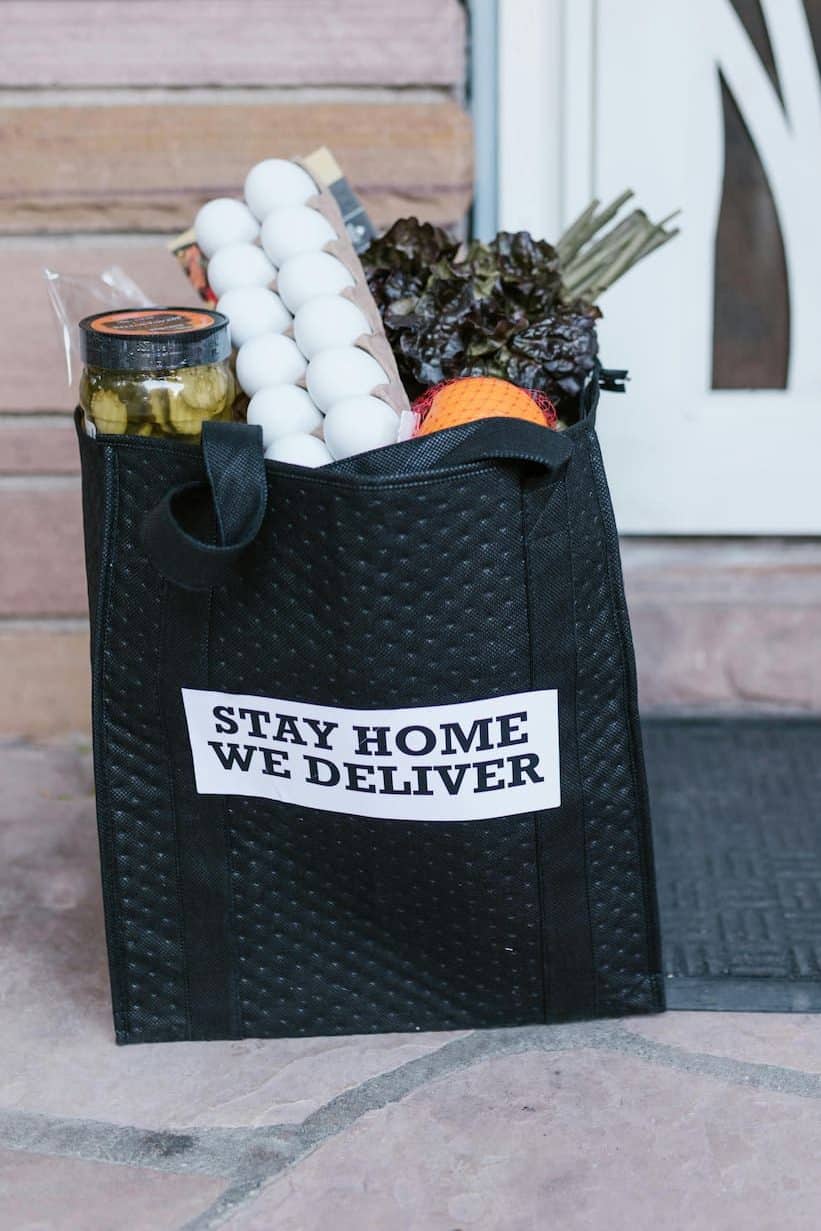A bag of groceries that were delivered sitting outside of the door. 