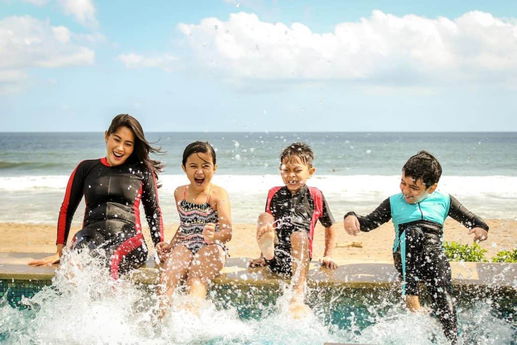 Image of a single parent with her 3 kids on vacation which she was able to make a part of her budget. 