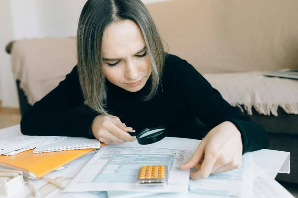 Image of a single parent analyzing her finances in preparation of creating a budget. 